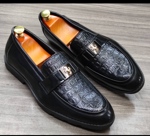 This is a nice pair of dark brown shoes. It is unique and comes unique. Made up of golden metals at the top. This shoe makes one looks attractive and presentable for any occasions. It can be used for office and any other celebrations one plan to attend. The soles are very strong and solid and it has a round front and the inside leather is brown. Available size 40 - 45.