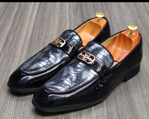 This is a nice pair of black shoes. It is unique and comes unique. Made up of golden metals at the top. This shoe makes one looks attractive and presentable for any occasions. It can be used for office and any other celebrations one plan to attend. The soles are very strong and solid and it has a round front and the inside leather is brown. Available size 40 - 45.