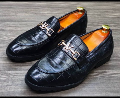 This is a nice pair of black shoes. It is unique and comes unique. Made up of golden metals at the top. This shoe makes one looks attractive and presentable for any occasions. It can be used for office and any other celebrations one plan to attend. The soles are very strong and solid and it has a round front and the inside leather is brown. Available size 40 - 45.