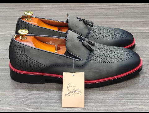 This is an outstanding pair of shoes. It is unique and comes unique. Made up of flexible leather. This shoe makes one looks attractive and presentable for any occasions. It can be used for celebrations and outings. The soles are very strong and solid and it has a round front and the shoe is dark grey in color. It has a red line round the shoe making it more attractive. Available size 40