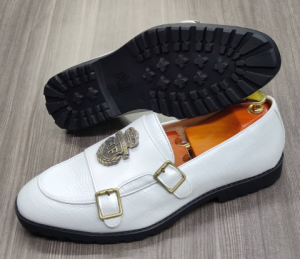 This is an outstanding pair of white shoes. It is unique and comes a unique white color. Made up of golden metals at the top and on the sides. This shoe makes one looks attractive and presentable for any occasions. It can be used for office and any other celebrations one plan to attend. The soles are very strong and solid and it has a round front and the inside leather is brown. Available size 41 - 44.